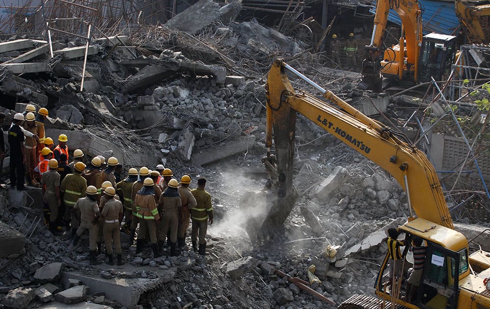 Rescuers search amid the rubble of a building that collapsed on the outskirts of Chennai, India.