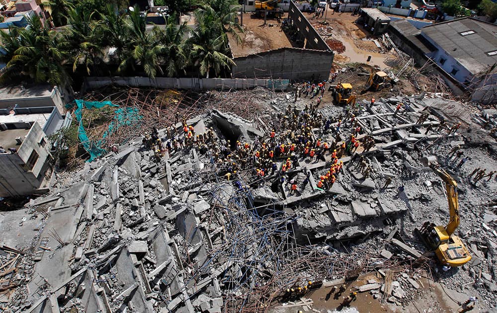 Rescuers search amid the rubble of a building that collapsed on the outskirts of Chennai, India.