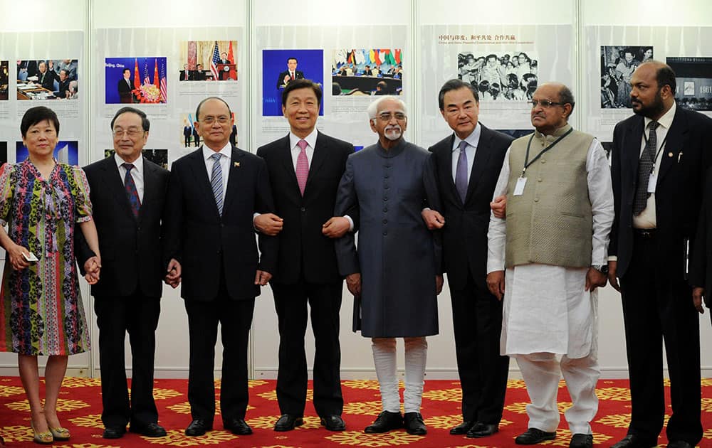 Myanmar President Thein Sein, third from left, Indian Vice President Hamid Ansari, fifth from left, and Chinese Vice President Li Yuanchao, fourth from left, pose for a group photo during their visit to a photo exhibition marking the 60th anniversary of the Five Principles of Peaceful Coexistence at Diaoyutai state guesthouse in Beijing.