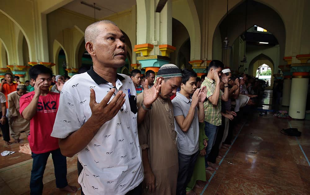 Filipino Muslims gesture as they pray during the first day of the holy fasting month of Ramadan at the Golden Mosque in downtown Manila, Philippines.