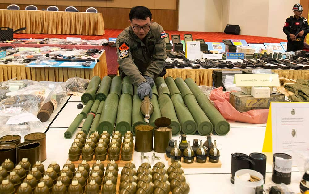 Thai police officers display rocket propelled grenades they seized during raids from May 22 to June 25 at a news conference in Bangkok, Thailand.