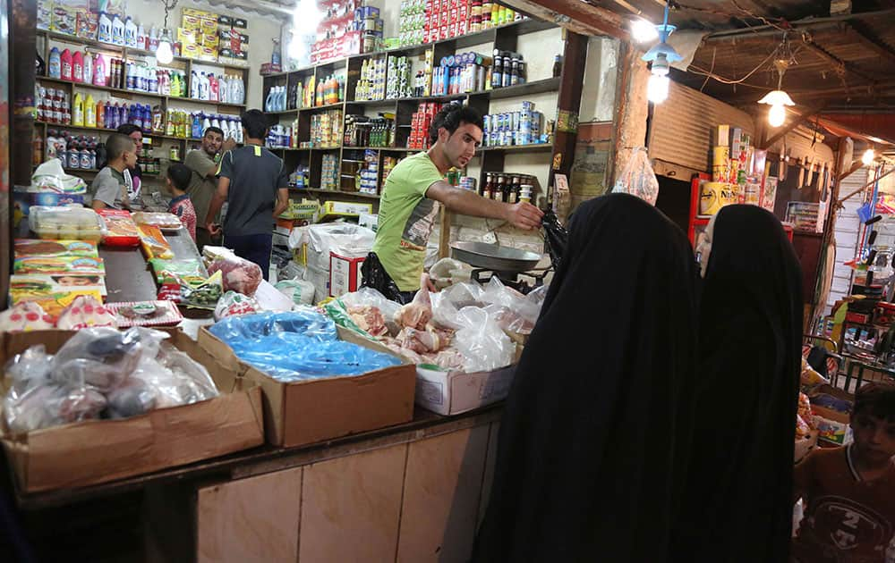 Iraqis shop for food in a preparation for the Muslim fasting month of Ramadan in Baghdad, Iraq.