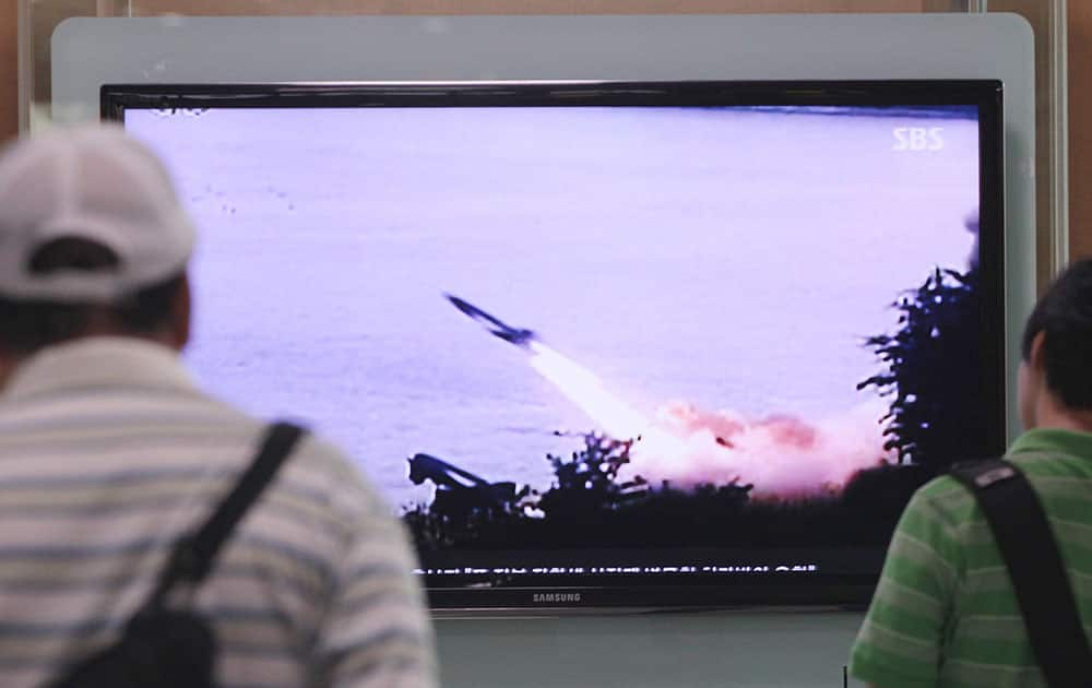 People watch a TV news program showing the missile launch conducted by North Korea, at Seoul Railway Station in Seoul, South Korea.