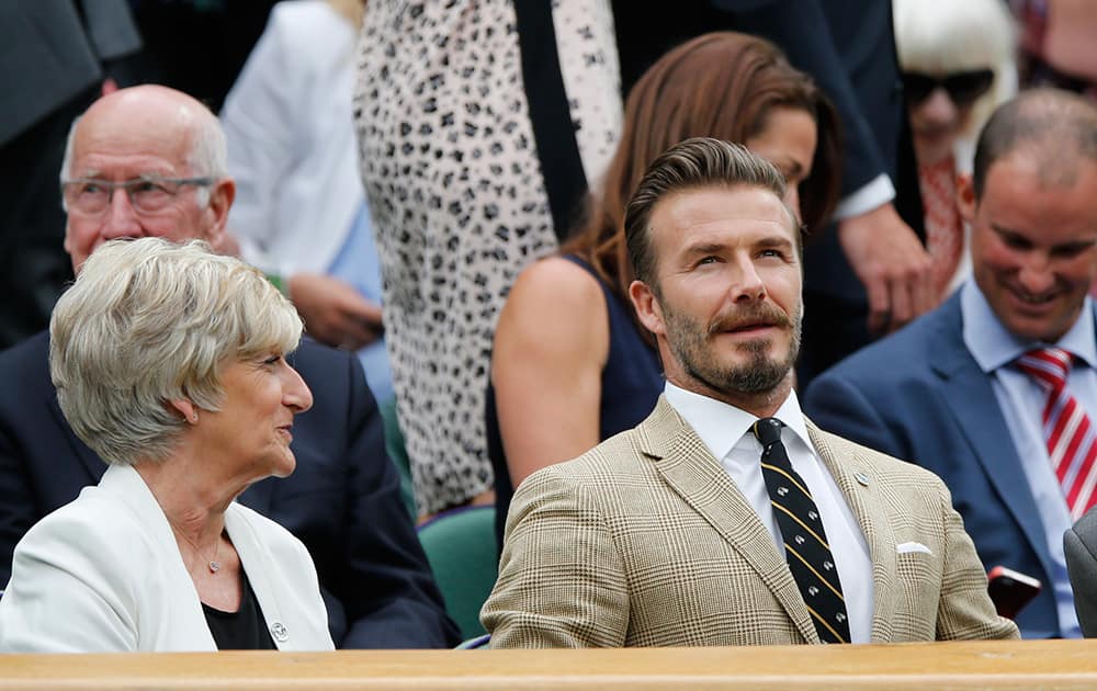 David Beckham and his mother Sandra Beckham sit in the Royal Box on centre court at the All England Lawn Tennis Championships in Wimbledon, London.