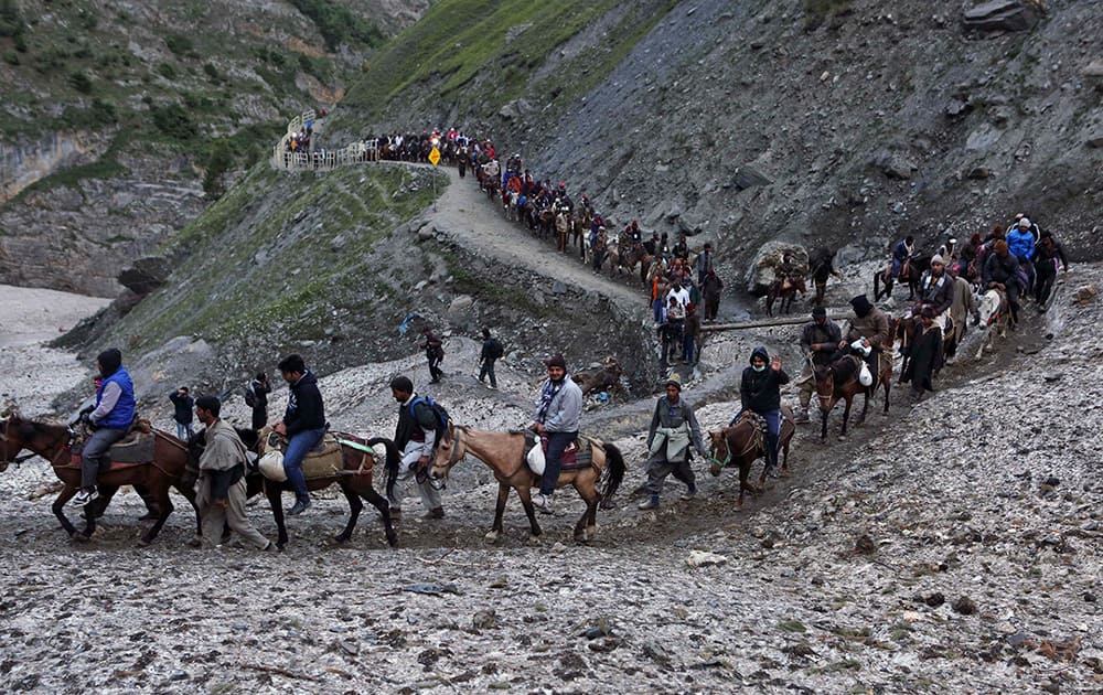 Hindu pilgrims ride in line as they journey to the Amarnath cave, near Baltal, 125 kilometers (78 miles) northeast of Srinagar.