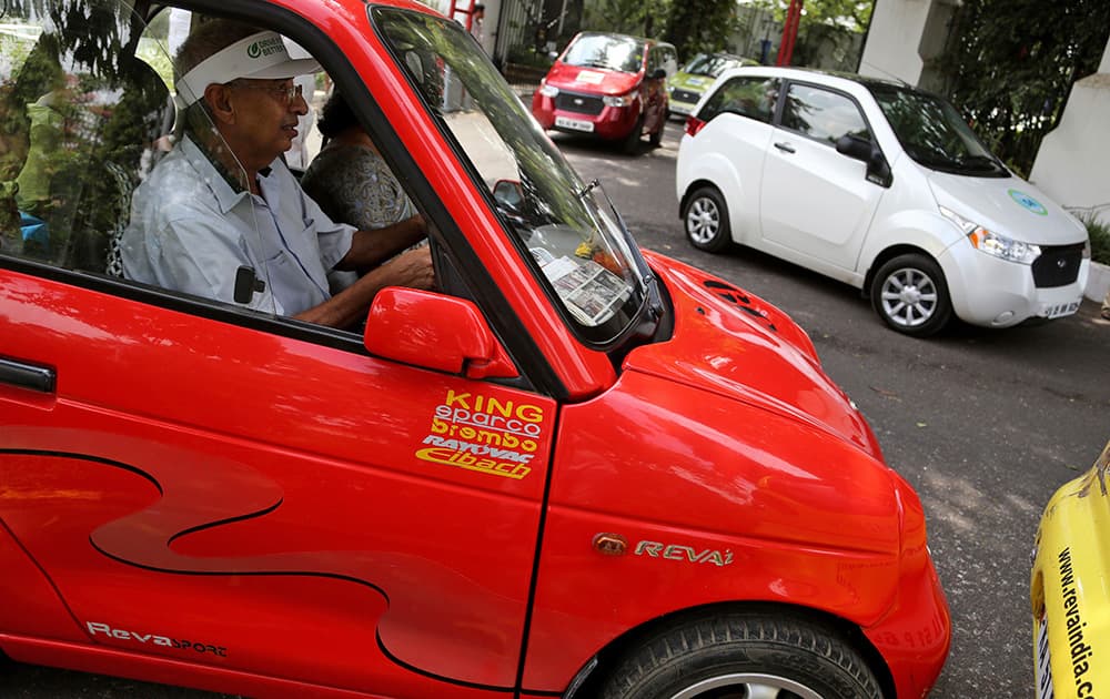 A man drives a Mahindra Reva electric car during a rally organized to create awareness about energy efficient and alternative modes of personal transport in Bangalore.