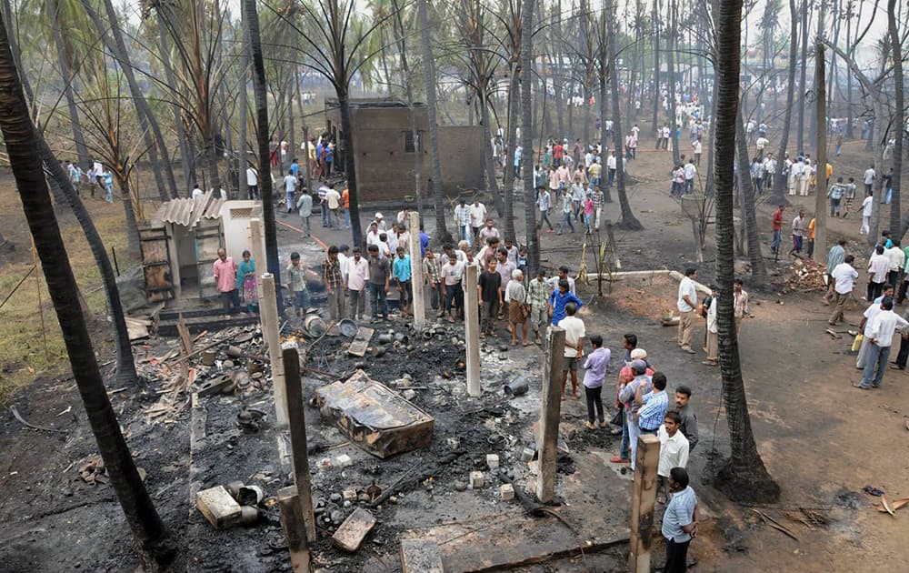 People gather at the site of a pipeline explosion in Nagaram village near Rajahmundry in East Godavari district.