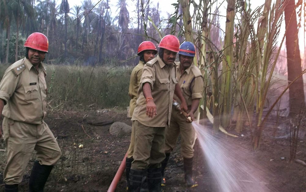 Fire men dousing at gas pipeline fire in Nagaram village near Rajahmundry in East Godavari district.