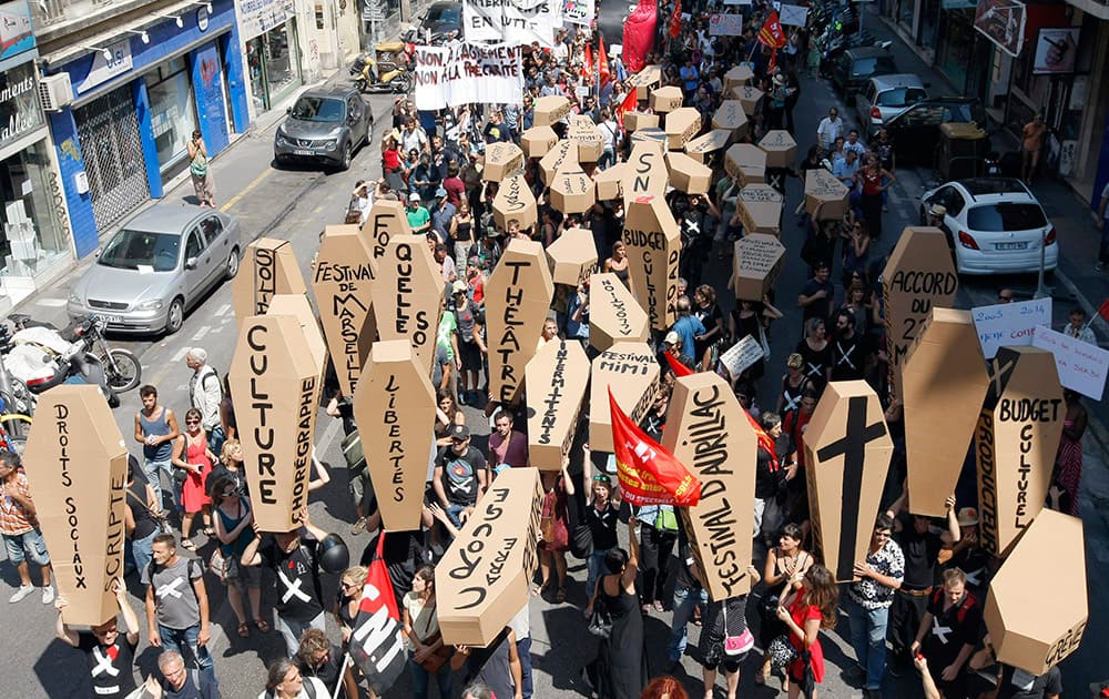 Part-time and temporary arts workers, striking artists and theater personnel, known as `intermittents`, hold fake coffins as they take the streets in Marseille, southern France, to protest against government plans to reform the unemployment benefits insurance agreement.