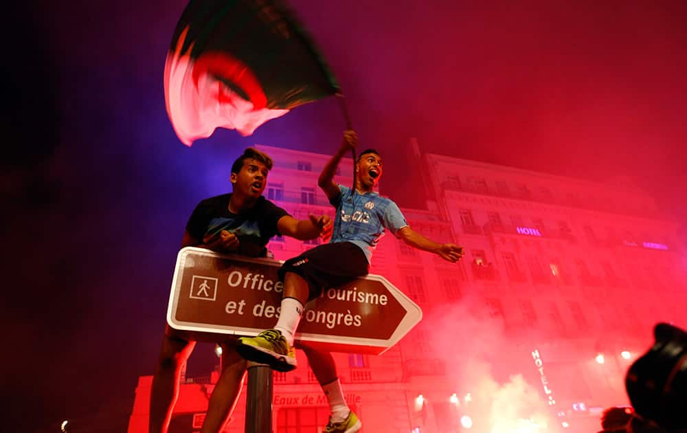 Algerian soccer fans celebrate after their team qualified for the World Cup, in Marseille, southern France.