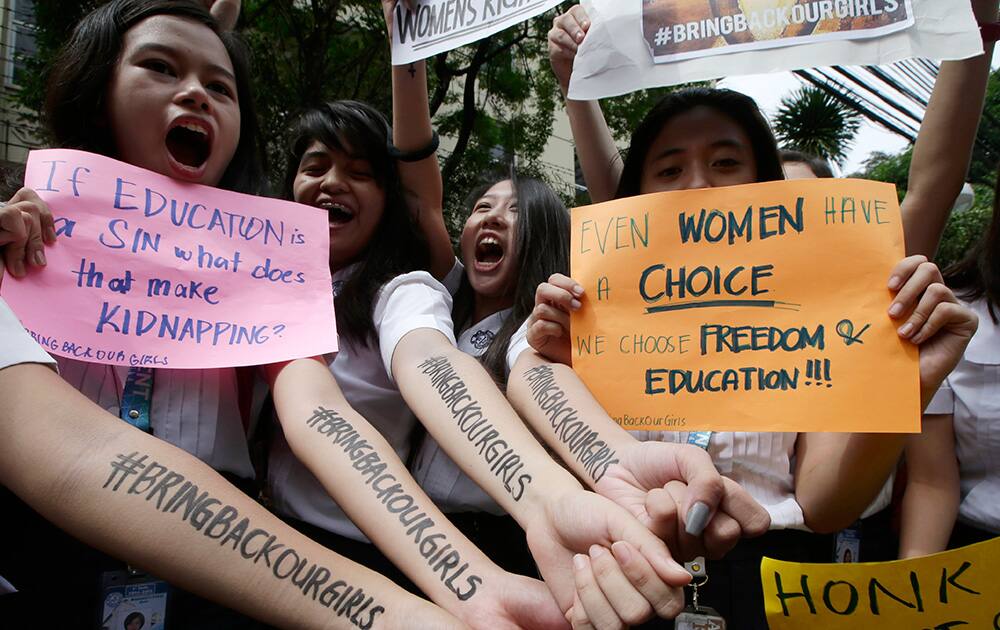 Students from St. Scholastica`s College, a Catholic school in Manila, show the message on their forearms as they shout slogans and display placards during a protest outside their campus in Manila, Philippines. Thousands of Filipino students from the school joined Friday a global campaign to free more than 200 schoolgirls abducted by Islamic extremists in Nigeria.