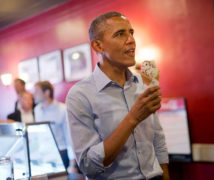 President Barack Obama holds his ice cream cone during a visit to Grand Ole Creamery in St. Paul, Minn.