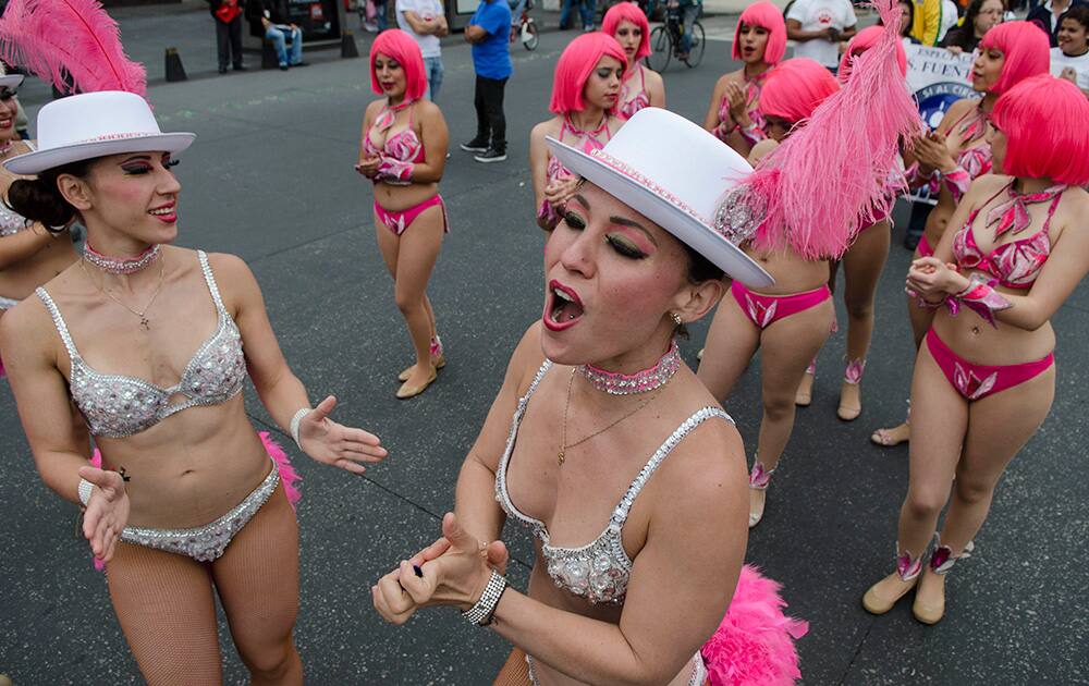 Karla Rosales, center, a performer in the Fuentes Gasca Brothers Circus, leads a chant during a protest against approved legislation that bans the use of animals in circuses, in Mexico City.