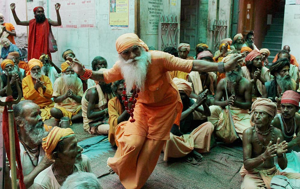 Sadhus dance and sing as they wait to register for the annual pilgrimage to the Amarnath shrine at a base camp in Jammu.