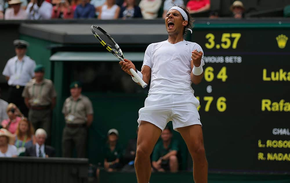 Rafael Nadal of Spain celebrates as he defeated Lukas Rosol of Czech Republic in their men`s singles match on Centre Court at the All England Lawn Tennis Championships in Wimbledon, London.