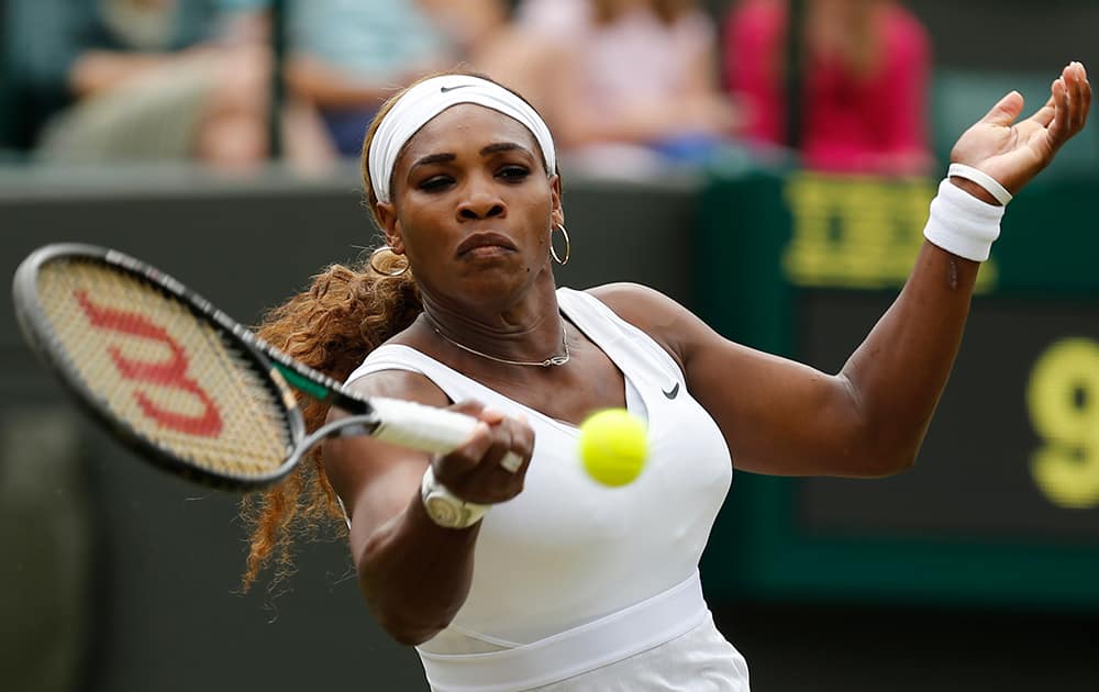 Serena Williams of U.S. plays a return to Chanelle Scheepers of South Africa during their women`s singles match at the All England Lawn Tennis Championships in Wimbledon, London.