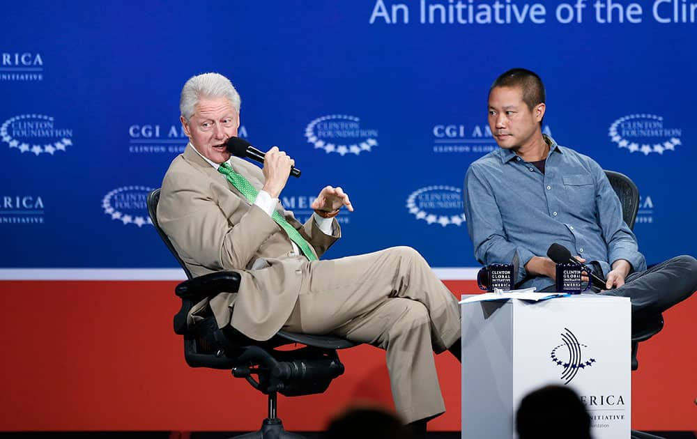 Former President Bill Clinton speaks with Zappos CEO Tony Hsieh, during a forum on the final day of the annual gathering of the Clinton Global Initiative America, at the Sheraton Downtown, in Denver.