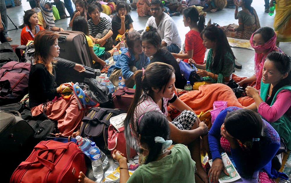 Railway passengers wait at Guwahati Railway Station as trains have been cancelled or delayed due to the Delhi–Dibrugarh Rajdhani Express that derailed at Chapra in Bihar.