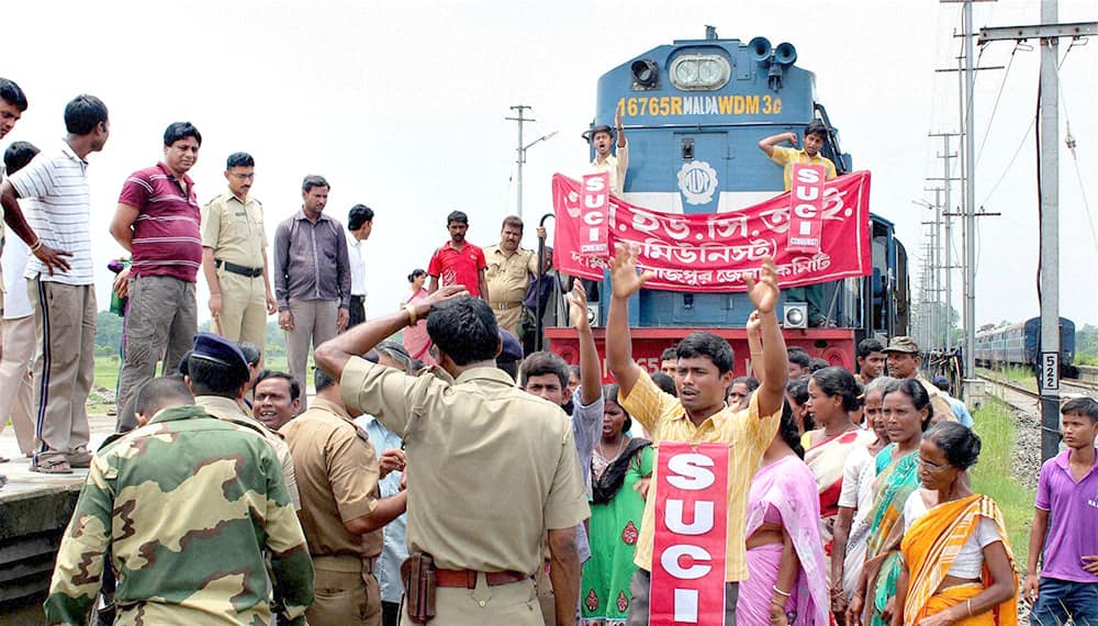 SUCI activists stop the Balurghat-New Jalpaiguri Intercity Express train to protest against the hike rail fare hike at Balurghat Railway station in South Dinajpur district of West Bengal.