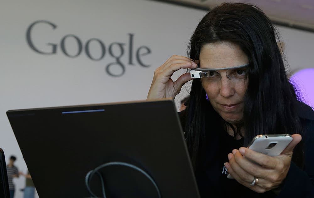 Cecilia Abadie, founder of 33 Labs, uses a pair of Google Glass as she registers for Google I/O 2014 at the Moscone Center in San Francisco.