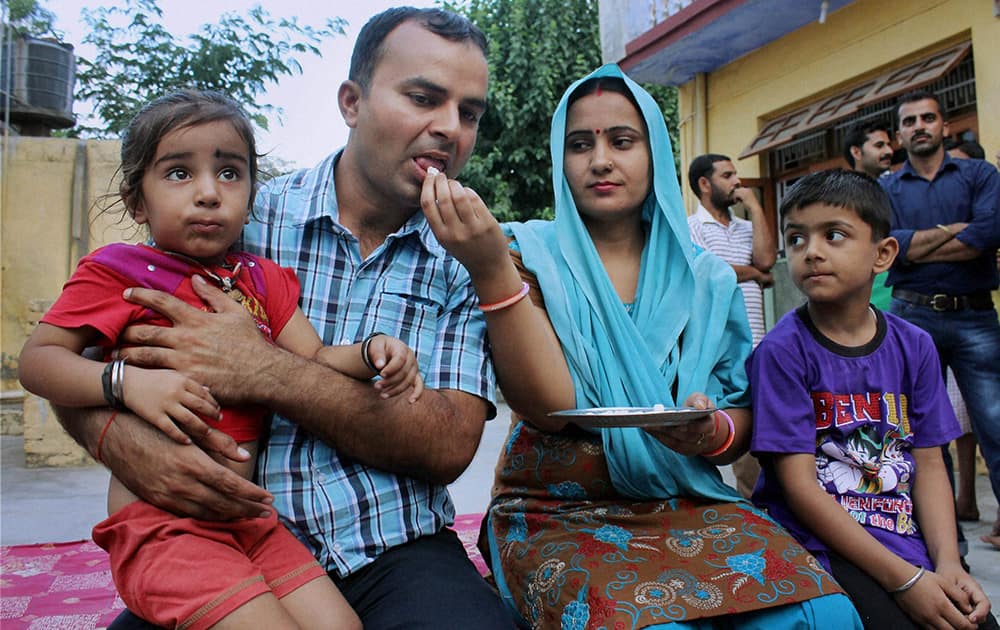 Indian construction worker Rajesh Kumar, one of 40 Indian workers abducted in the Iraqi city of Mosul by militants, with his families at Miran Sahib in Jammu.