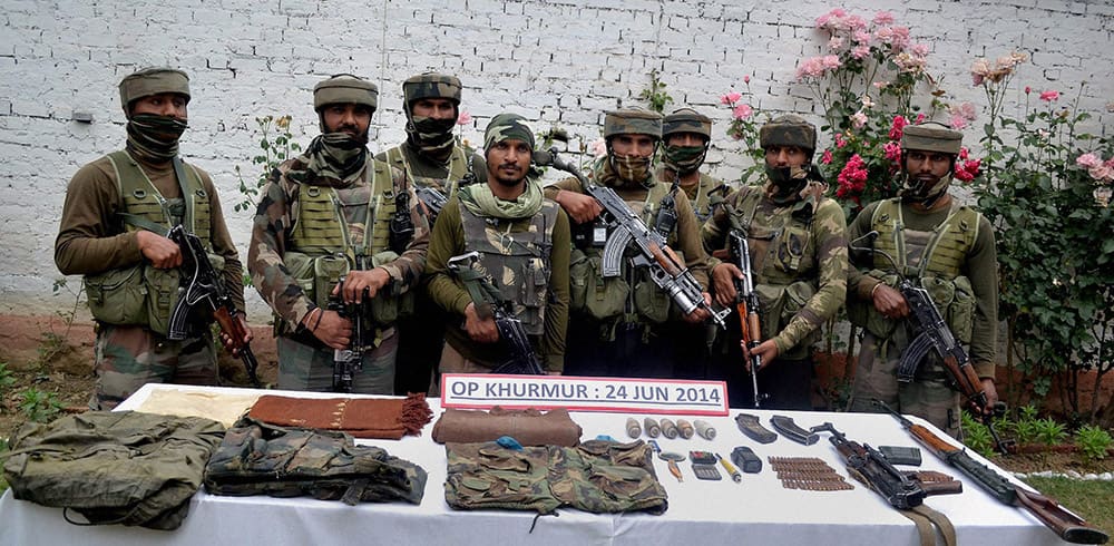 Army personnel display arms and ammunition recovered from Lashkir-e-Toiba (LeT) hideout during an anti-militant operation at Rajwara Forests in Kupwara.