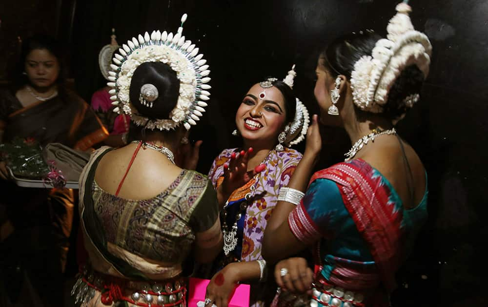 Dancers share a light moment backstage before performing during a classical dance festival in Bangalore.