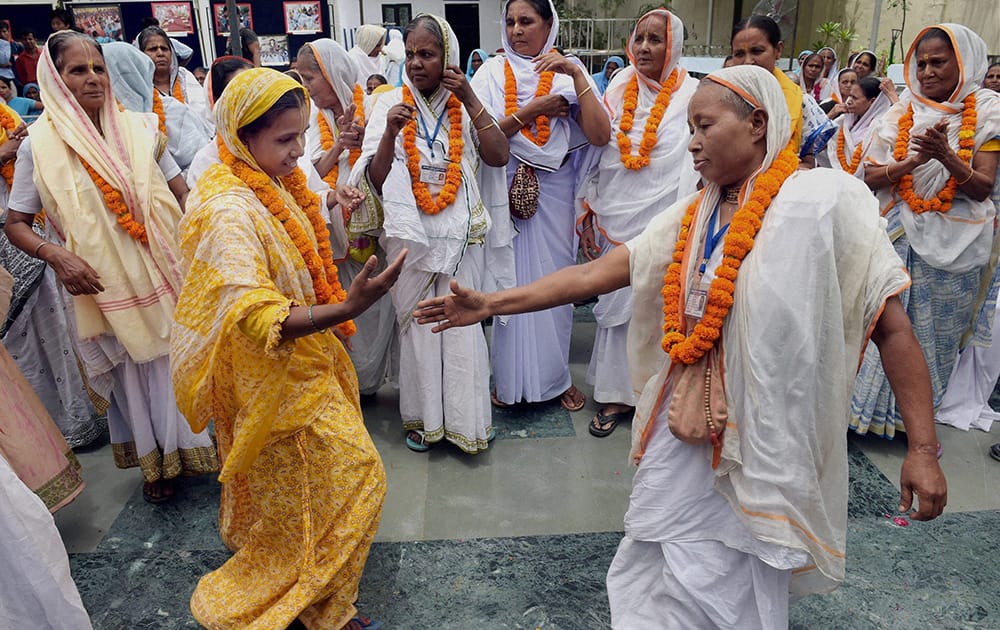 Widows from Virandavan perform a dance as they take part in an event to mark International Widows` Day in New Delhi.