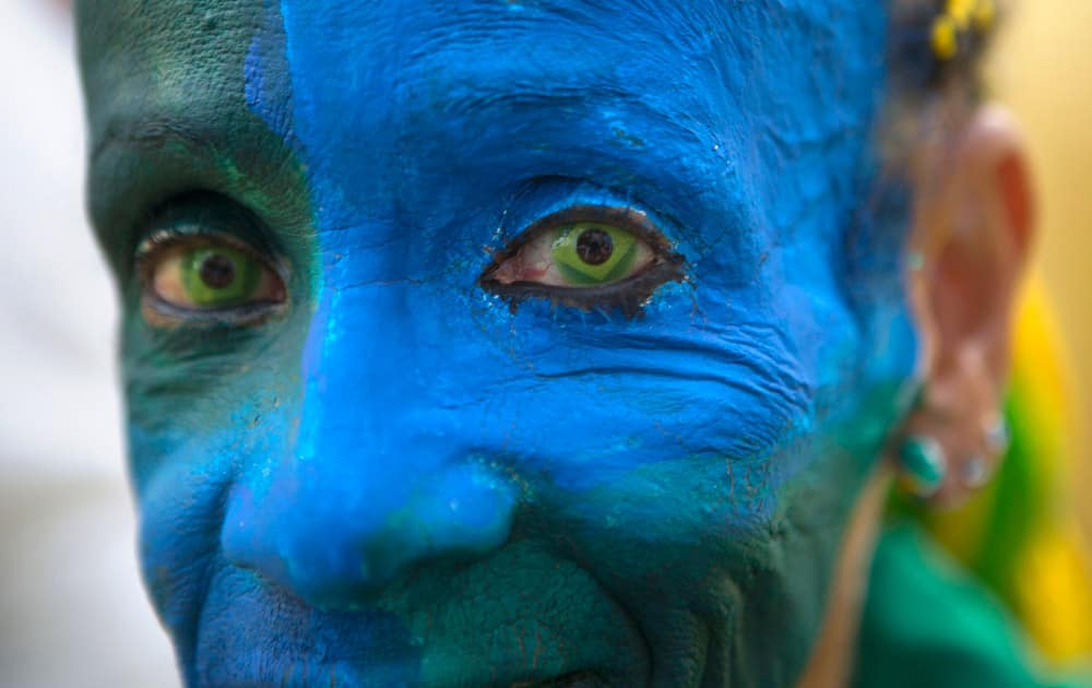 A fan wears contact lenses with a Brazilian flag motif, as she waits for the live broadcast of the group A World Cup soccer match between Mexico and Brazil.