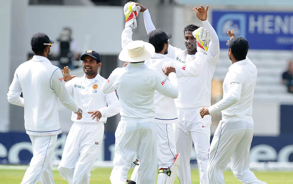 Sri Lanka`s captain Angelo Mathews, second right, celebrates with teammates after England`s Stuart Broad was caught by Lahiru Thirimanne for 4 runs, during day three of the Second Test Match between England and Sri Lanka at Headingley cricket ground, Leeds, England.