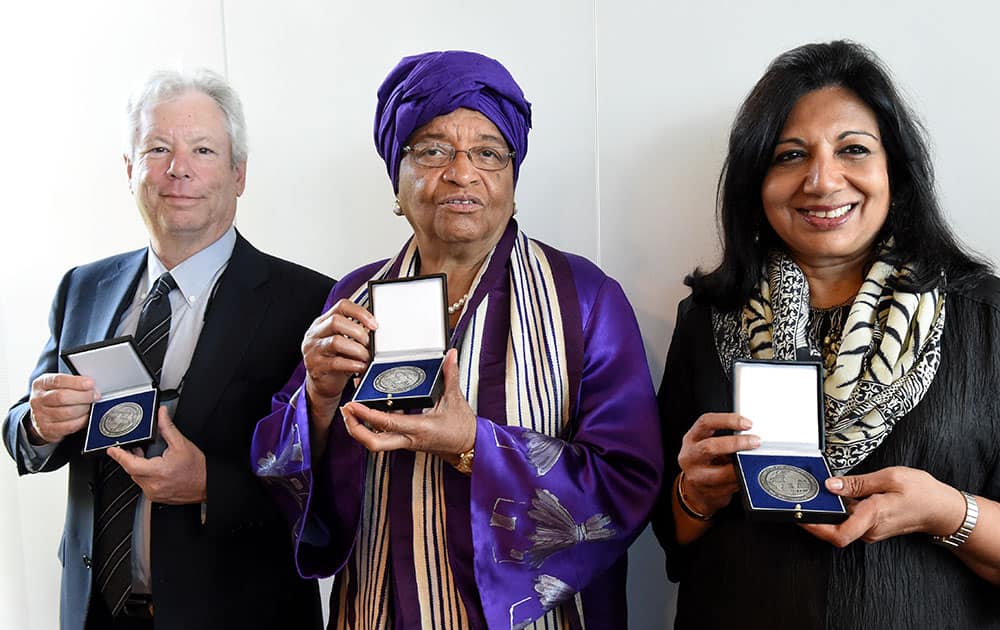 From left: US economist Richard Thaler, Liberia`s president Ellen Johnson-Sirleaf and Indian entrepreneur Kiran Mazumdar-Shaw pose for the media after being awarded with the 2014 Global Economy Prize of the Kiel Institute for World Economy, in Kiel, northern Germany.