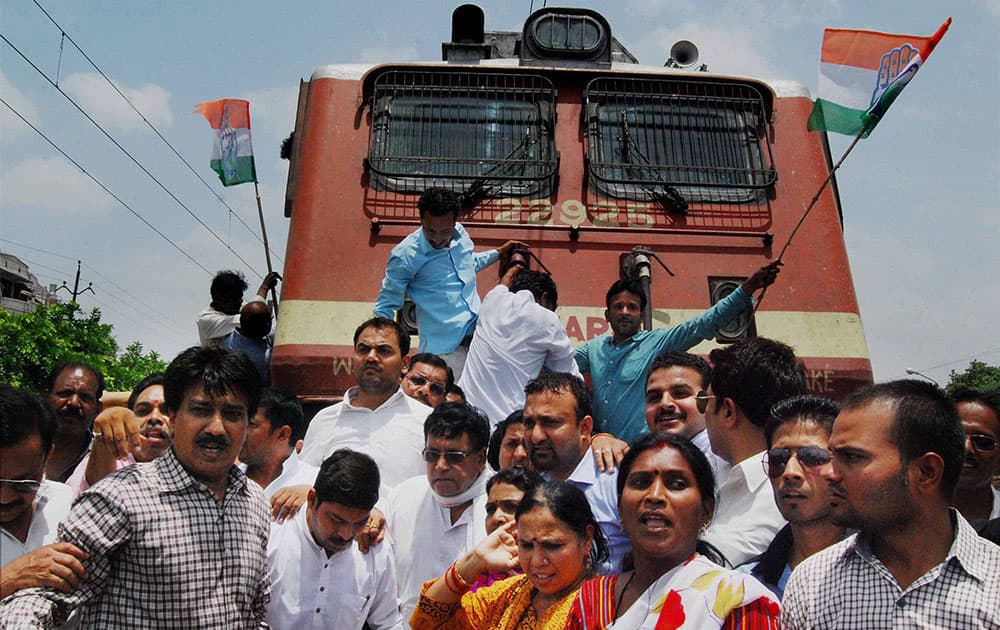 Congress activists block a train passage while protesting against hike in the Railway fares in Bhopal.