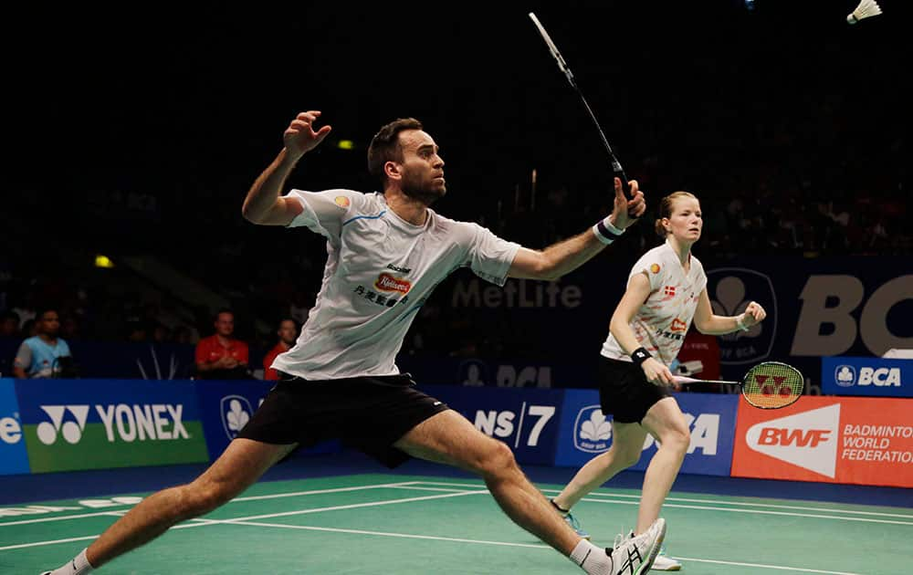 Denmark`s Joachim Fischer Nielsen, left, returns a shot against China`s Xu Chen and Ma Jin while his team mate Christinna Pedersen looks on during their mixed doubles final match at the Indonesia Open badminton championship at Istora Stadium in Jakarta, Indonesia.