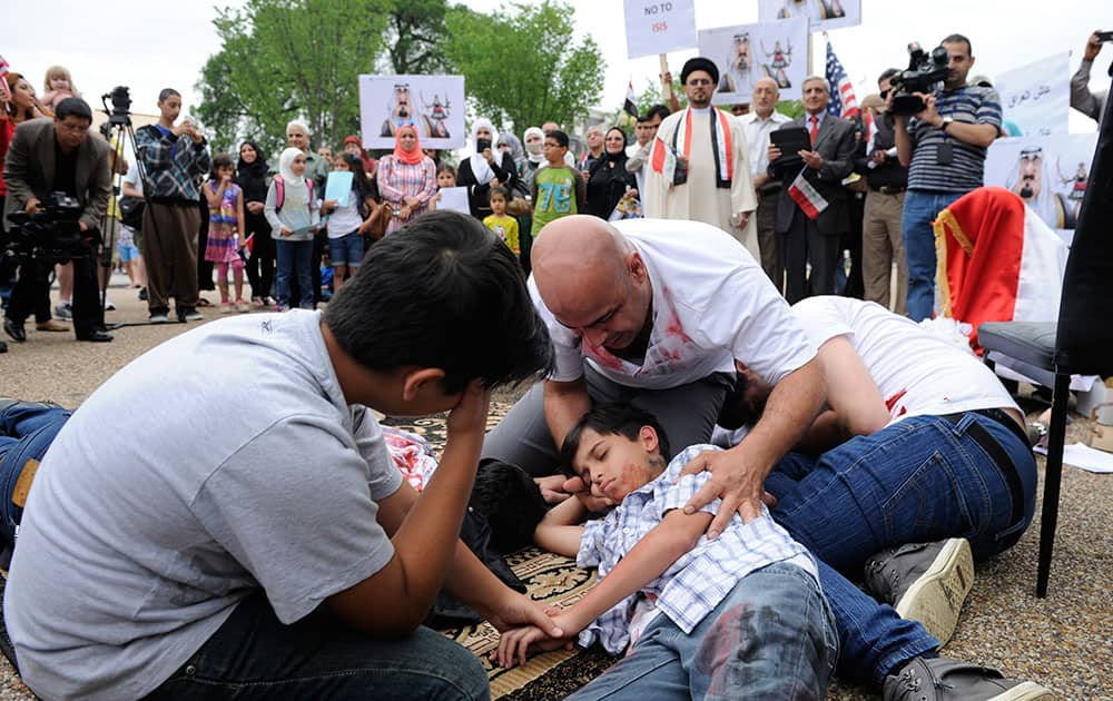 Members of an Iraqi youth theater group perform part of their play `Broken Dreams` on Pennsyllvania Ave., outside the White House in Washington.