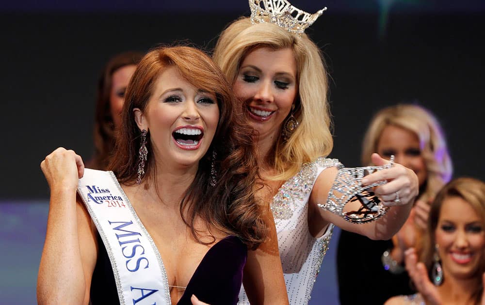 Ashton Campbell, left, celebrates being named Miss Arkansas with last year`s winner Amy Crain at the Miss Arkansas Pageant in Hot Springs, Ark.