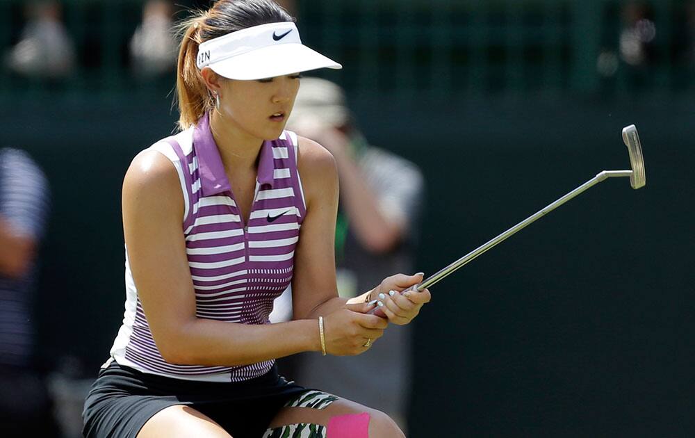 Michelle Wie reacts after missing a putt on the fifth hole during the third round of the U.S. Women`s Open golf tournament in Pinehurst, N.C.