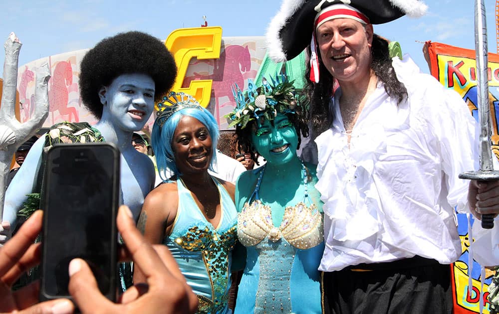 Mayor Bill de Blasio, right, and his wife Chirlane McCray, second from left, pose for a photograph with their children Dante de Blasio, left, and Chiara de Blasio as they take part in the Mermaid Parade in the Coney Island section of the Brooklyn borough of New York.