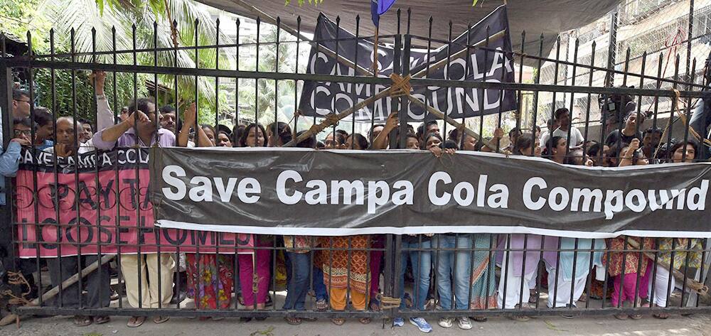 Campa Cola residents block the entrance for the BMC officials who arrived to disconnect the water and electricity supply of the society, in Mumbai.