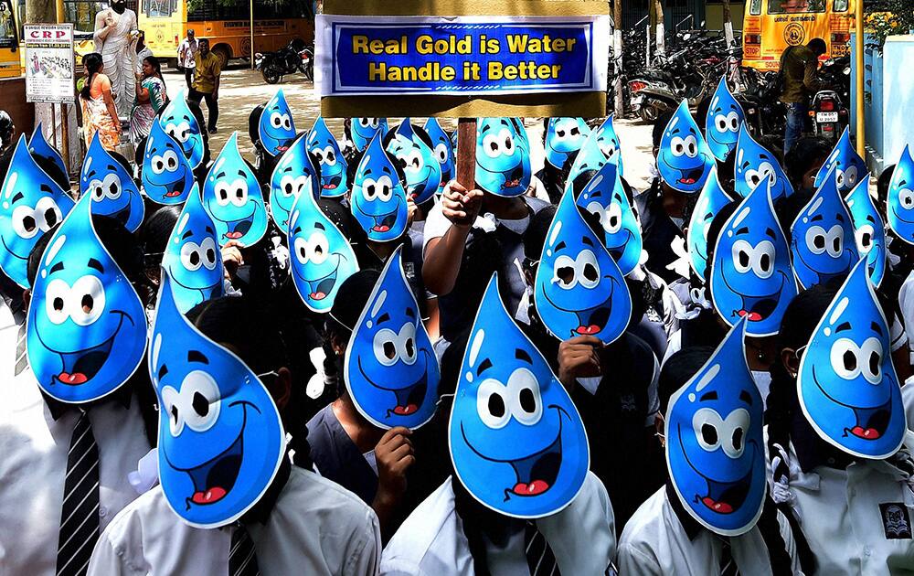 Students wear mask of water drops at a rally to encourage rainwater harvesting among people, in Chennai.