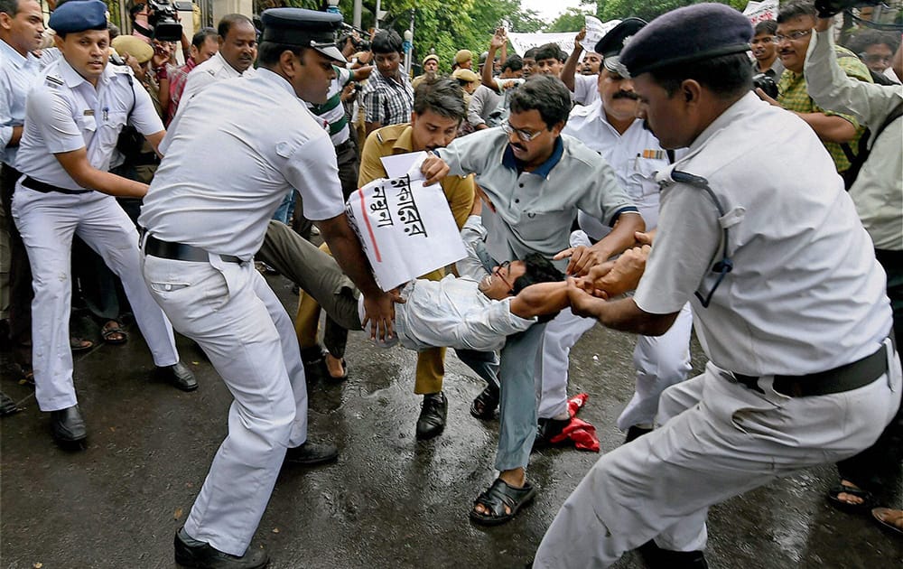 Police detain SUCI activists who were holding a protest in front of Governor house in Kolkata.