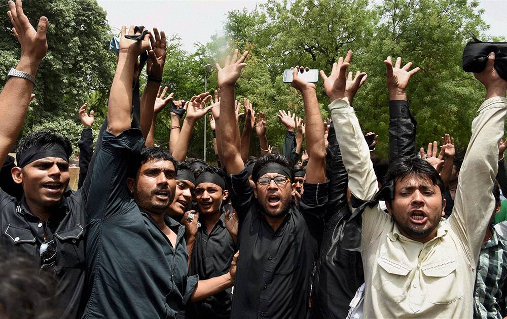 Muslims shout slogans during a demonstration against terror attacks in Iraq, at Jantar Mantar in New Delhi.