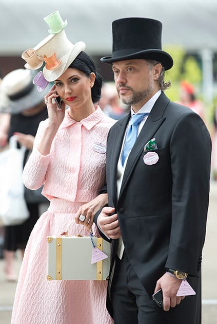 Olga Stepanenko and Valerii Lapter walk in the parade ring on the third day of the Royal Ascot horse racing meeting, which is traditionally known as Ladies Day, at Ascot, England.