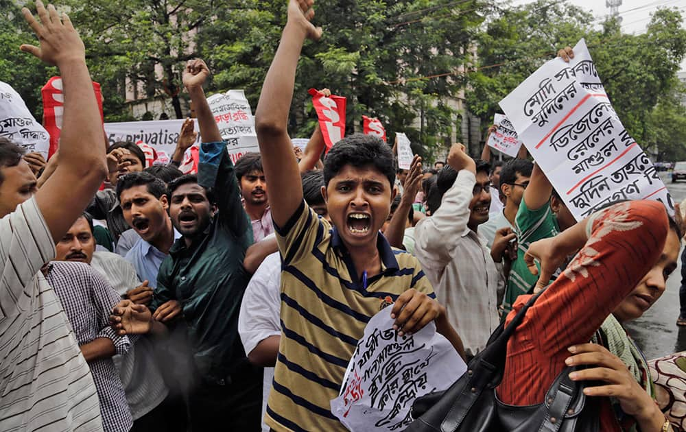 Activists of Socialist Unity Center of India (SUCI) shout slogans during a protest against hike in rail fare, outside the Governor`s house in Kolkata.