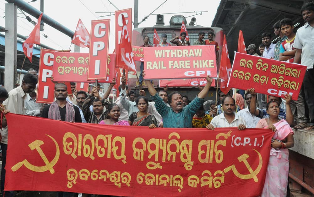 CPI workers stop a Rajdhani Express train during a protest against railway fares, in Bhubaneswar.