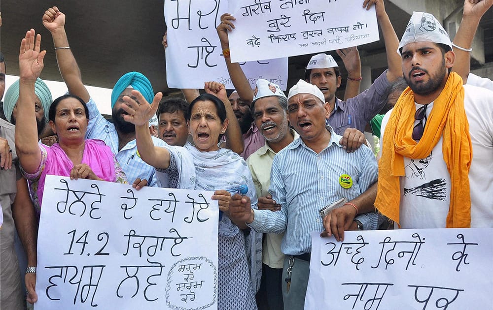 AAP volunteers shout slogans during a protest against proposed rail fare hike, in Patiala.