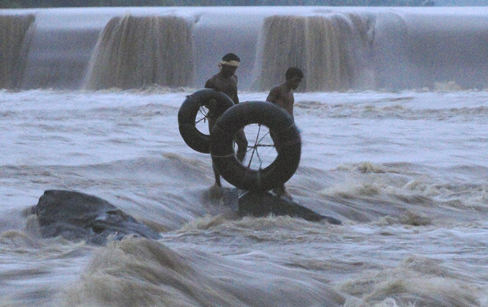 Locals try to rescue ten youth who were trapped in Damodar River after Tenughat Dam released water which started overflowing due to rains, near Bokaro.