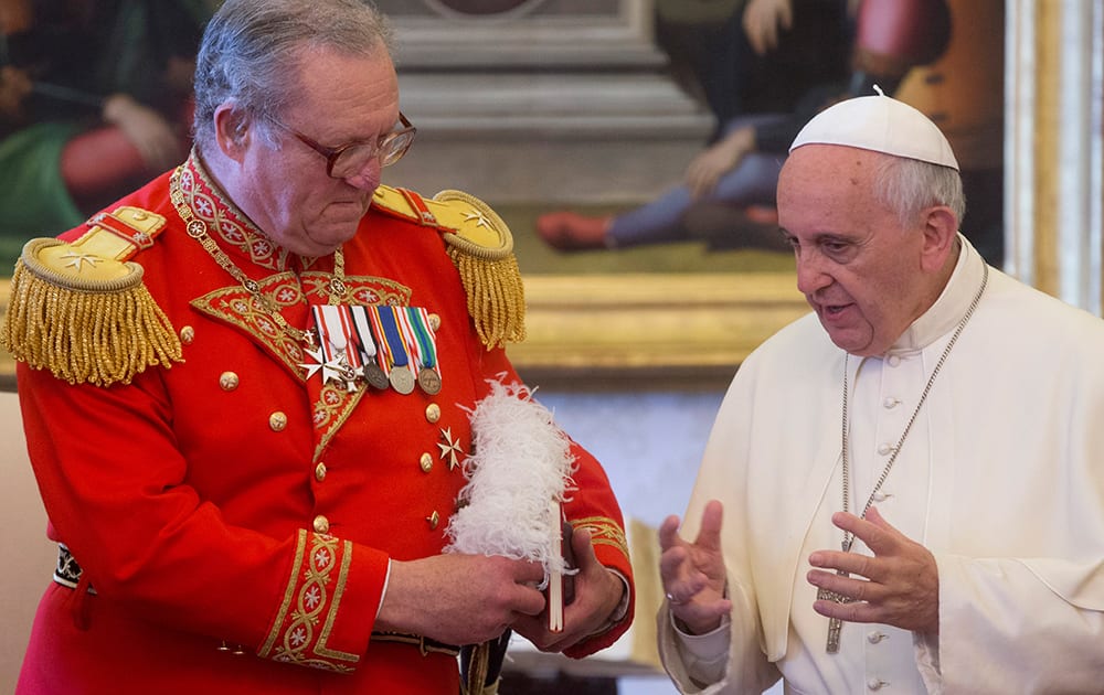 Pope Francis meets the Grand Master of the Sovereign Order of Malta, Fra` Matthew Festing, during a private audience in the pontiff`s private library at the Vatican.