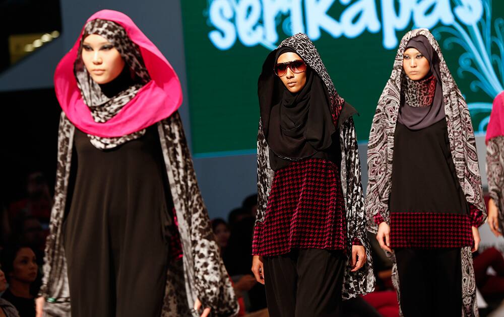 Models display creations by designer Serikapas during the Islamic Fashion Festival at the Malaysia International Fashion Week in Kuala Lumpur, Malaysia.