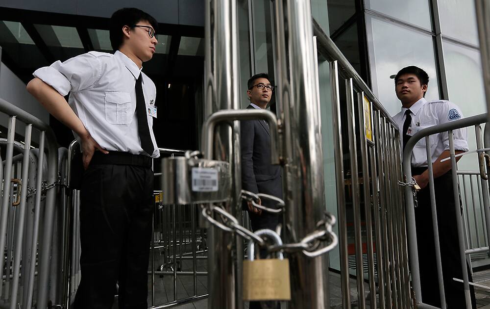 Security personals stand guard outside Legislative building in Hong Kong. Security stepped up after protesters, last Friday, against the government on a development plan in the North Eastern New Territories, storming at the Legco building with bamboo poles and smashed glass panels last Friday, police have arrested 24 people.