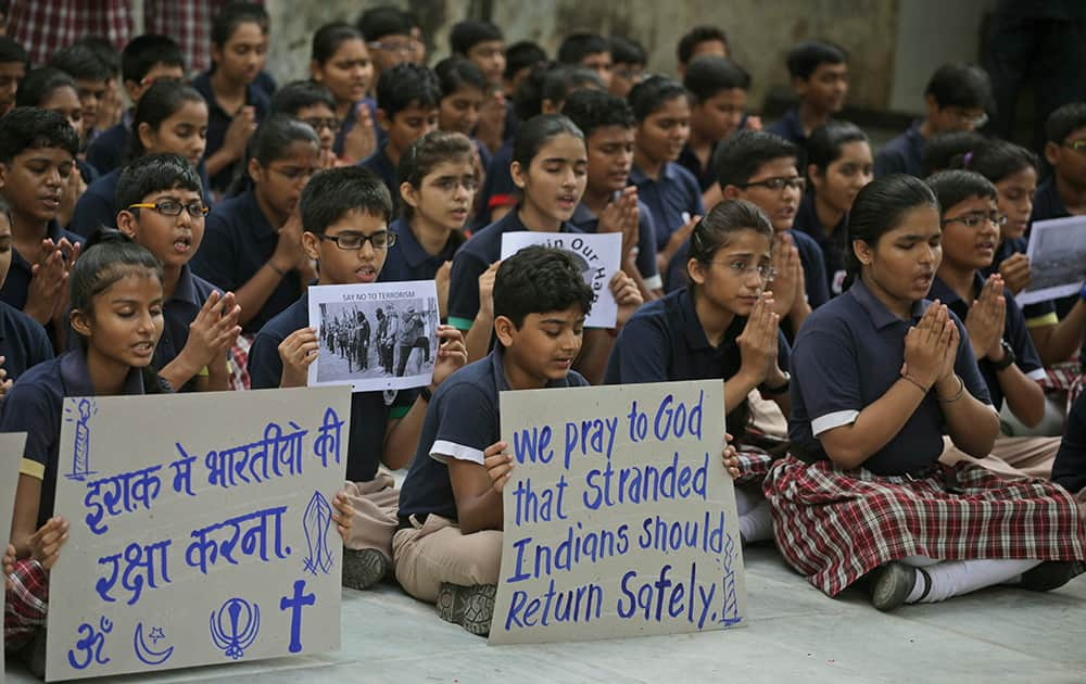 Indian schoolchildren hold placards as they pray for safety of Indians stranded in Iraq, in Ahmedabad. The Iraqi government has determined where 40 Indian construction workers abducted near Mosul are being held captive with workers of a few other nationalities, an official said Thursday.